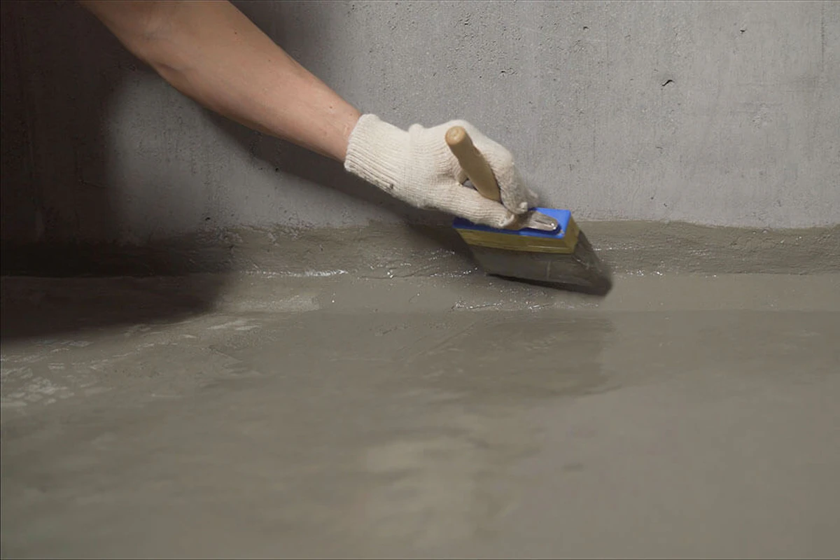 Painter painting a concrete floor