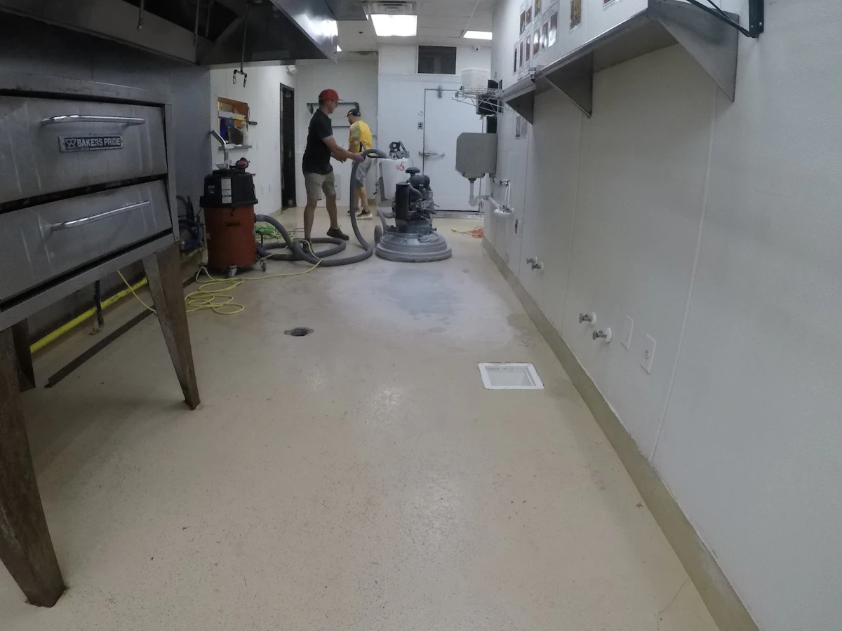 Polishing a concrete floor in a facility.