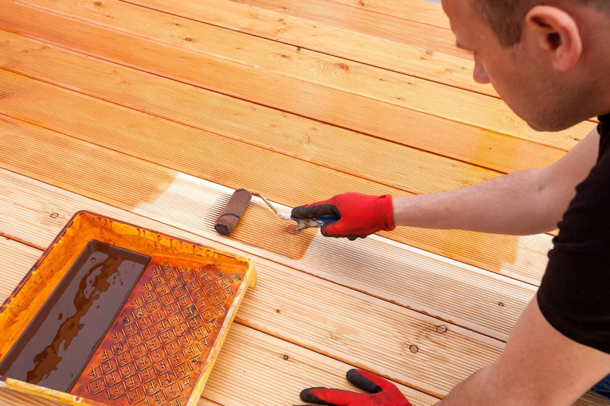 Man applying a deck stain