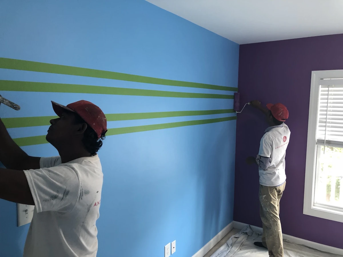 Two men painting the interior of a home.