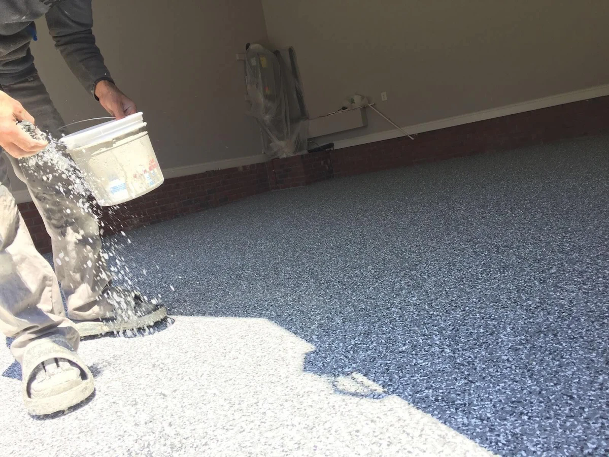Man working on a garage floor covering