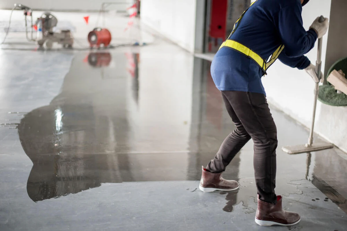 Painter polishing a concrete floor